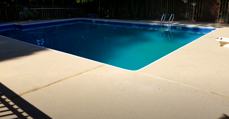 resurfacing a concrete slab around a pool.