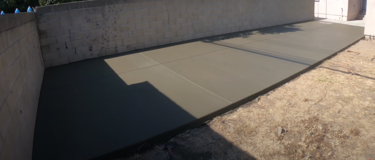 A plain concrete slab installed in the backyard for the husband to build his area on.